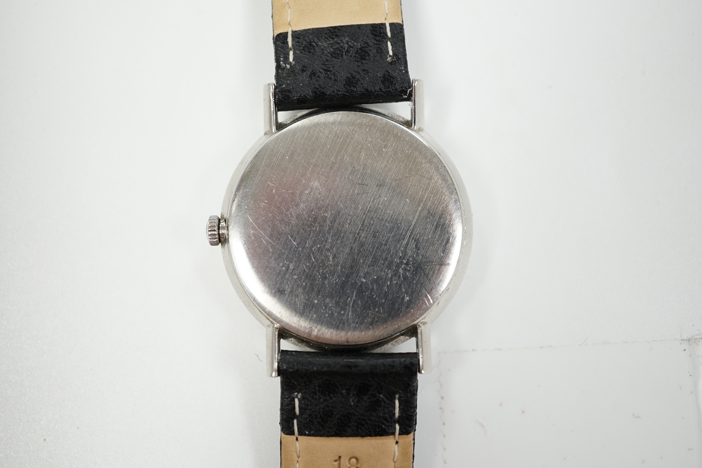 A gentleman's late 1960's stainless steel Omega manual wind wrist watch, with baton and quarterly Arabic numerals, case diameter 34mm, on later associated leather strap, with Omega box.